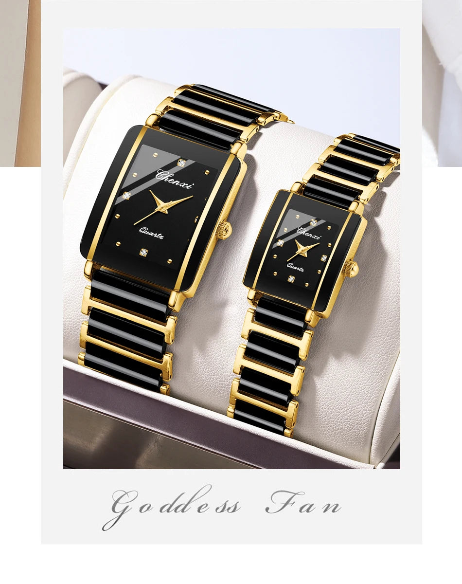 A pair of gold and black luxury quartz watches are displayed on a light-colored surface.