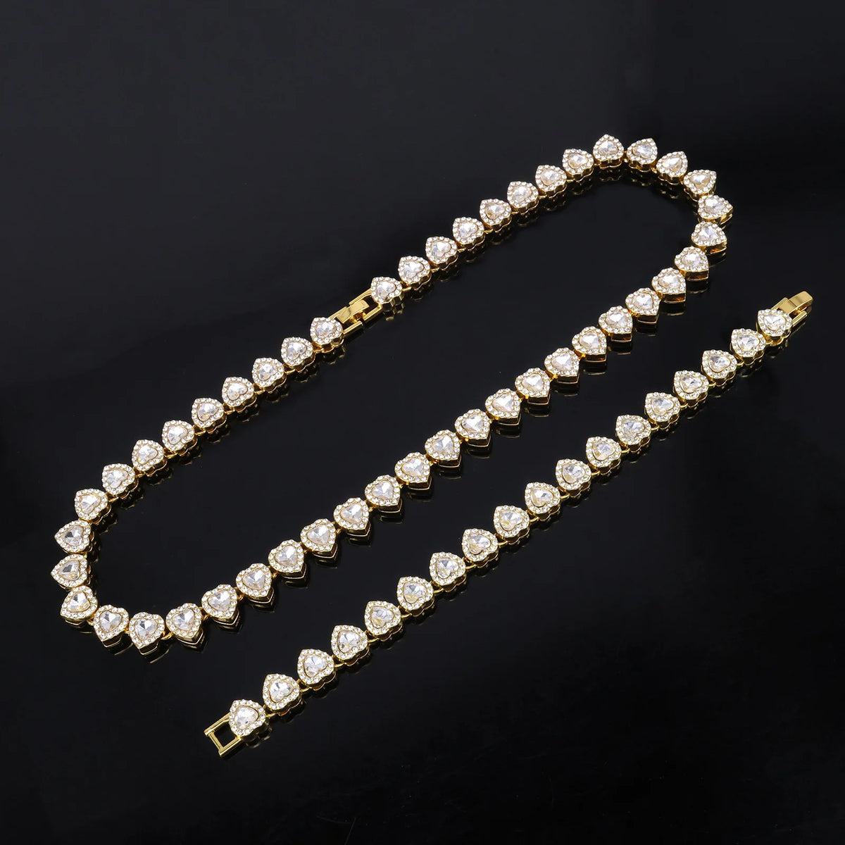 A set of sparkling heart rhinestone necklaces and bracelets displayed on a dark background.