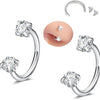 A set of silver horseshoe nose rings and stud earrings displayed on a white background.