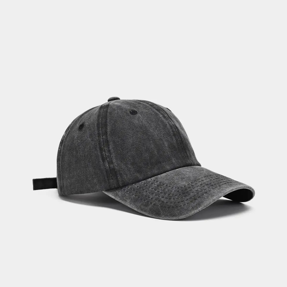 A dark gray washed cotton snapback cap shown from the side.