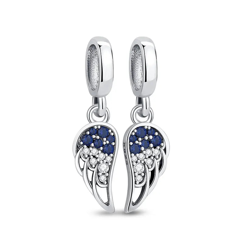 A pair of silver dangle earrings featuring a family tree charm design with blue and white accents.
