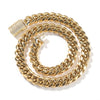 A gold stainless steel Cuban link necklace coiled in a circular shape.