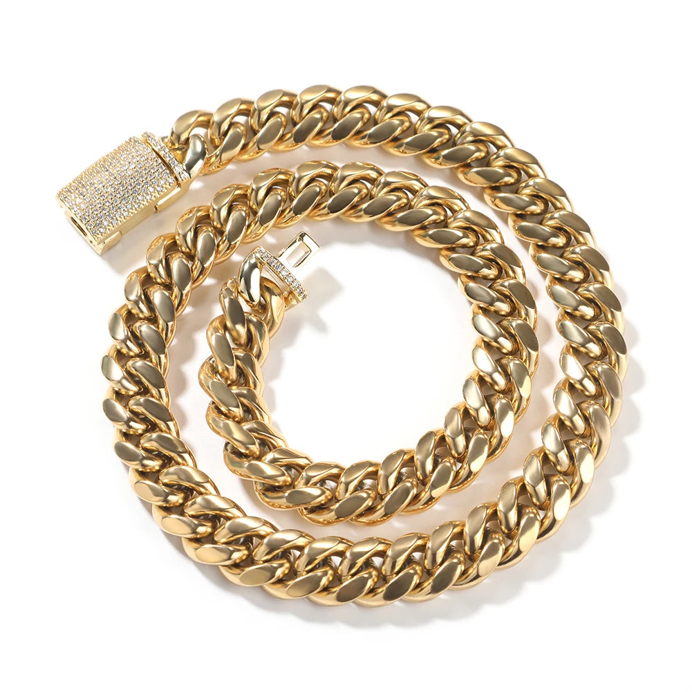 A gold stainless steel Cuban link necklace coiled in a circular shape.