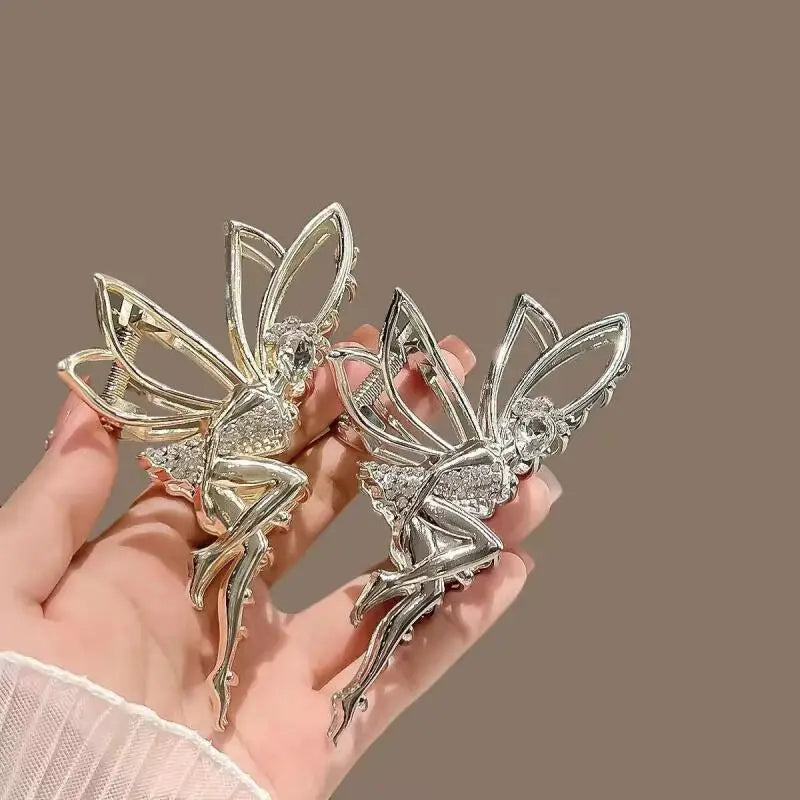 A pair of silver rhinestone butterfly hair clips are displayed against a neutral background.