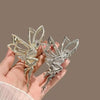 A pair of silver rhinestone butterfly hair clips are displayed against a neutral background.