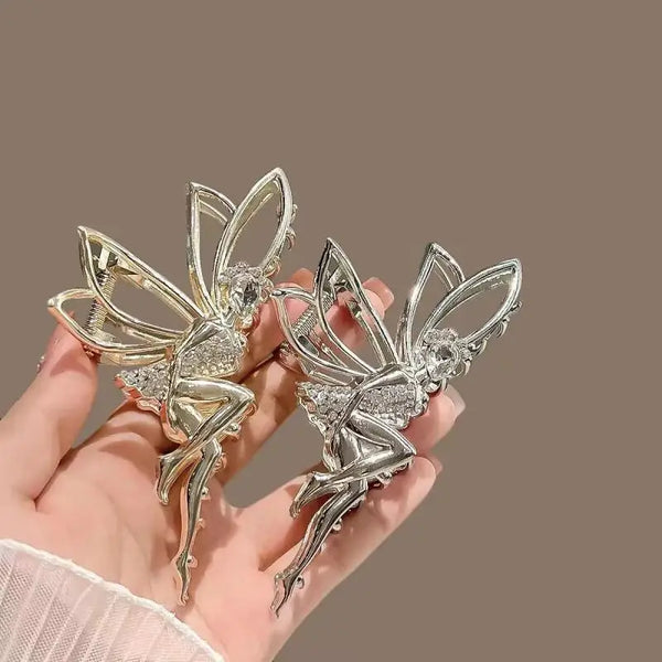 A pair of silver rhinestone butterfly hair clips are displayed against a neutral background.