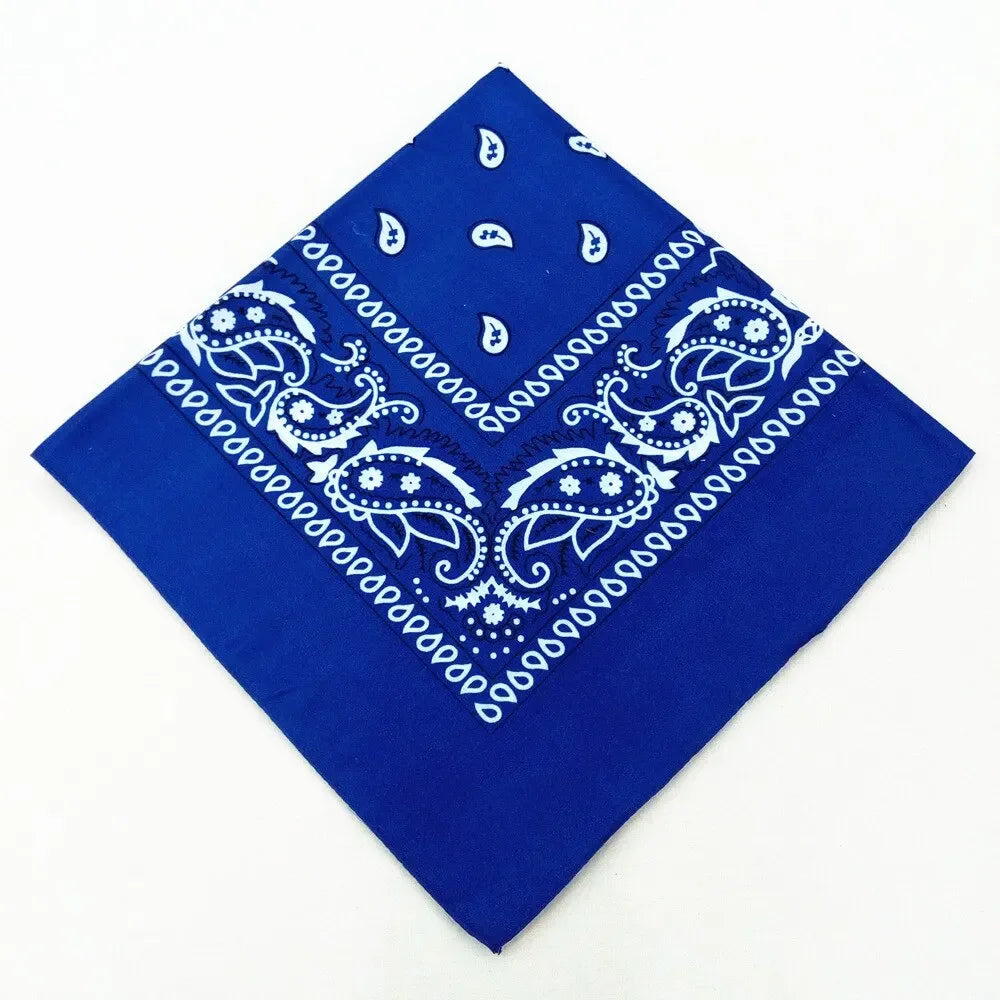 A royal blue bandana featuring white paisley and geometric patterns.