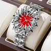 Silver quartz wristwatch with a dragon scale design and red center, displayed in a box.