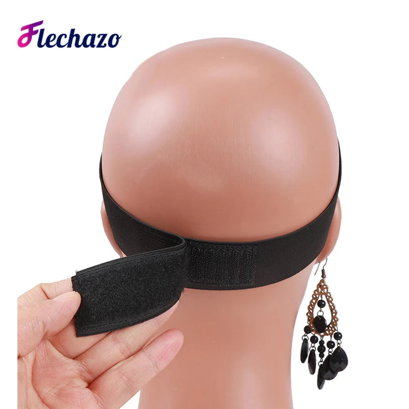 A hand holds a black elastic wig band for hair edges, displayed against a mannequin head.