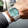 A close-up shot of a silver Satchi luxury men's waterproof quartz wristwatch on a person's wrist.