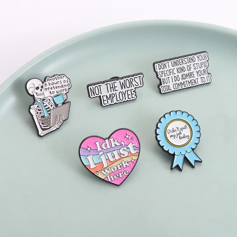 A collection of enamel pins featuring funny work quotes on a light gray background.