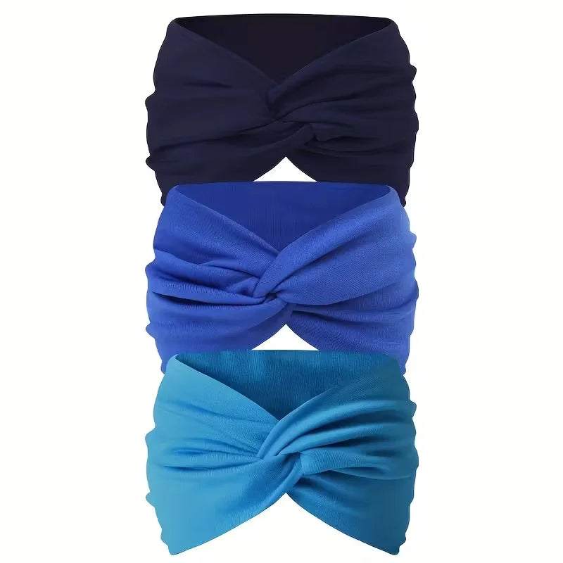 Ein Set aus drei rutschfesten Haarbändchen in Marineblau, Königsblau und Türkis, zu einer Schleife gebunden.