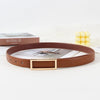 A brown faux leather belt with a gold buckle is displayed on a white background next to a book and some yellow beads.