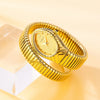 A gold quartz watch with a snake design is displayed on a clear block.