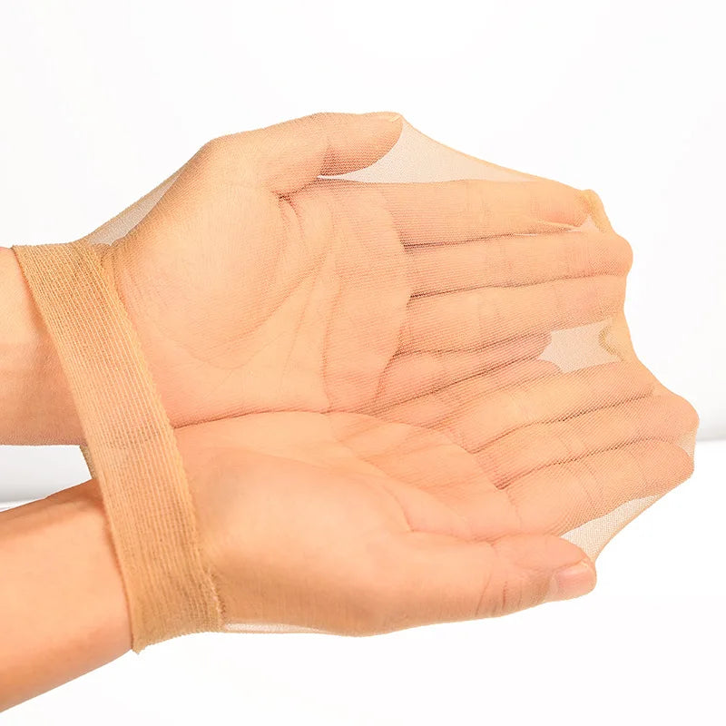 A hand wearing an invisible sheer wig cap for HD wigs, showing the translucent fabric covering the fingers.