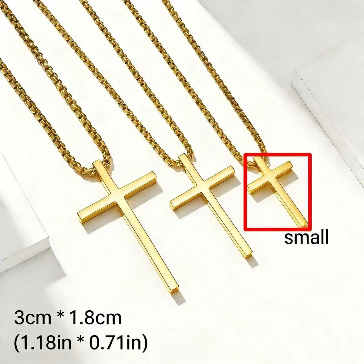Three gold stainless steel cross pendant necklaces displayed on a white background.