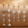 A set of five gold stainless steel dangled belly button rings featuring clear and diamond-cut stones.