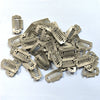A collection of precision hair extension clips in a metallic beige color.