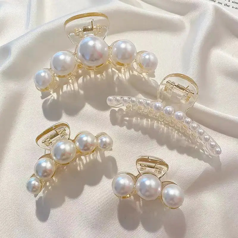 Clear acrylic hair claws adorned with small white simulated pearls