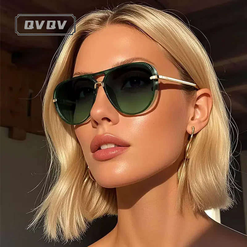 Une femme blonde modèle des lunettes de pilot vintage à monture métallique avec des verres vert foncé.