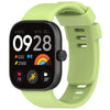 A lime green silicone watch strap with a black smartwatch face displaying fitness metrics and time.
