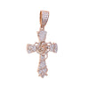 Pendentif croix ton or incrusté de pierres claires.