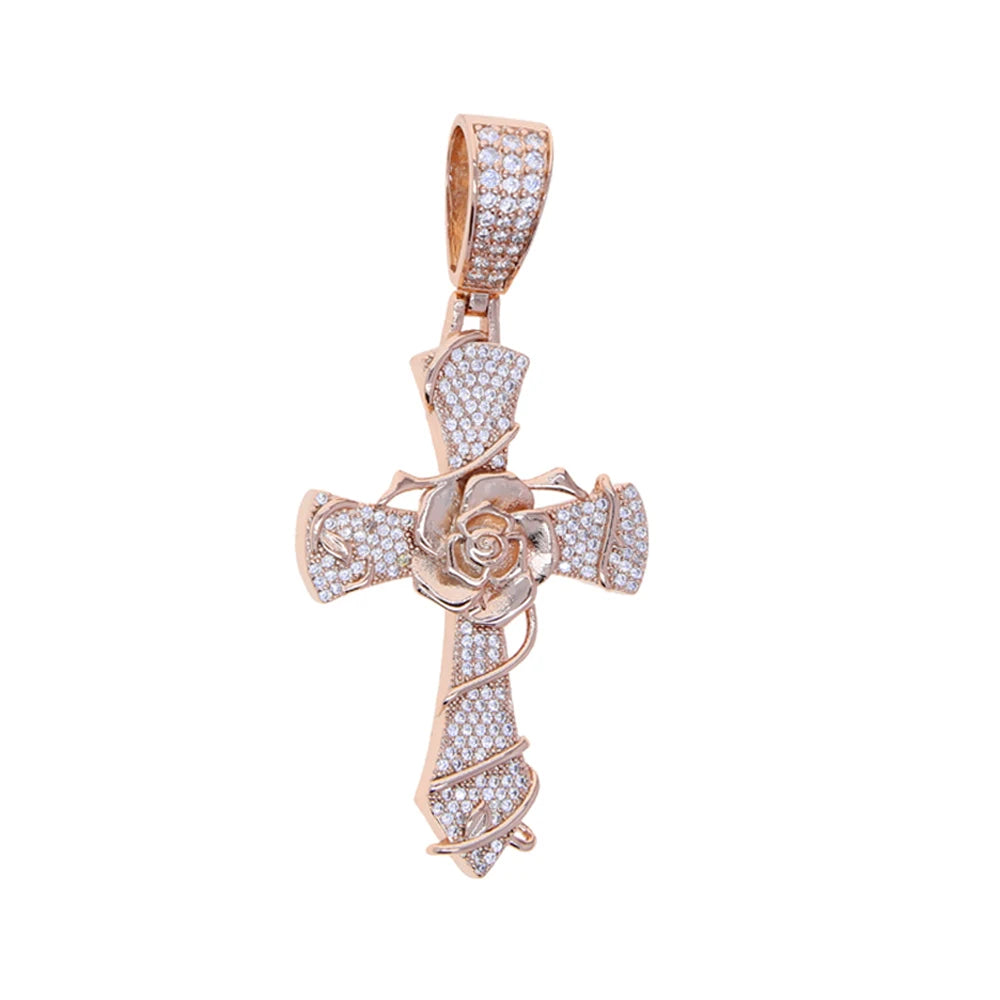 Pendentif croix ton or incrusté de pierres claires.