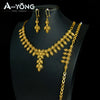 A set of luxury gold plated bridal jewelry featuring earrings and a necklace displayed on a black mannequin.