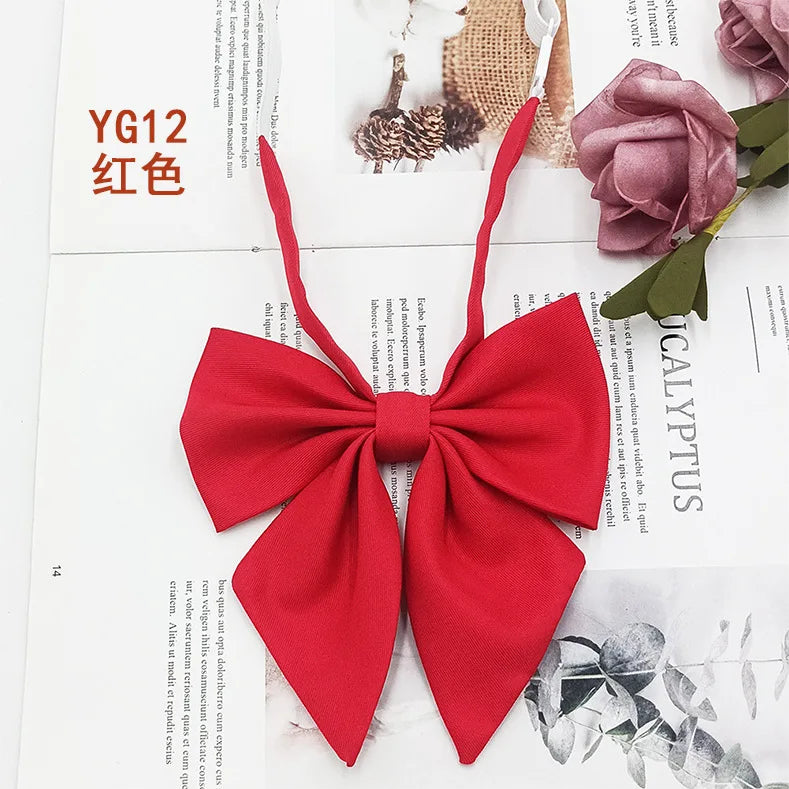 A solid red cotton bow tie tied in a bow shape, displayed on a white background.