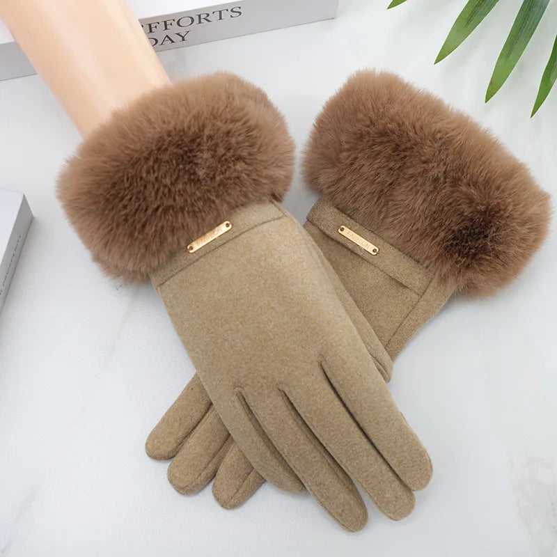 Tan suede gloves with fluffy brown faux fur cuffs resting on a white surface.