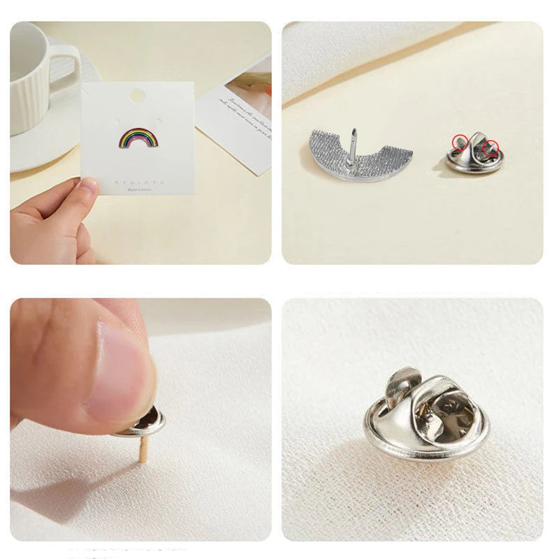 A set of enamel badge pins and decorative brooches shown on a white background.
