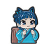 A cute anime character brooch featuring a blue-haired girl with large eyes and traditional clothing.