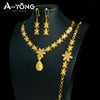 A set of luxury gold plated bridal jewelry featuring earrings and a necklace displayed on a black mannequin.