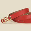 A close-up of a red leather belt with a gold buckle, showing the texture and stitching.
