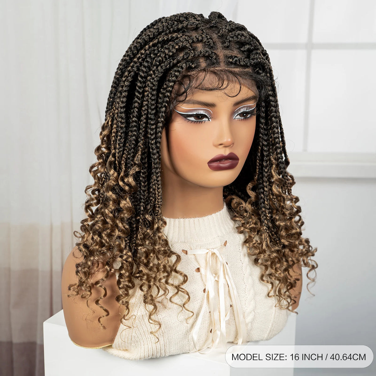 A model wears a long, dark brown boho box braid wig with intricate face painting and a cream-colored knit top.