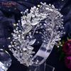 A delicate crystal bridal headband featuring intricate floral and leaf designs.