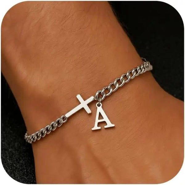 A close-up of a personalized stainless steel cross Cuban chain bracelet worn on a wrist.