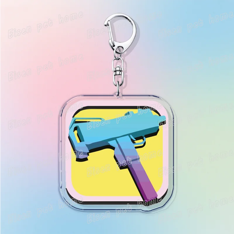 Silver pendant keychain featuring a retro blue and purple paint gun design on a yellow background