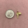 A silver coin and a gold-plated butterfly key pendant charm resting on a pink background.