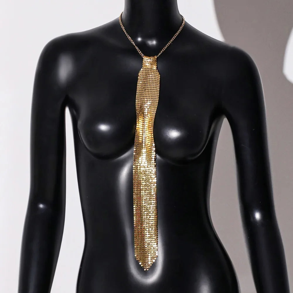A gold crystal rhinestone sequin neck tie necklace displayed on a black mannequin.