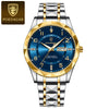 A luxury men's quartz watch featuring a blue luminous dial, gold accents, and a silver-tone bracelet.