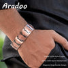 A close-up of a man's wrist wearing a copper magnetic bracelet with a strap buckle design.