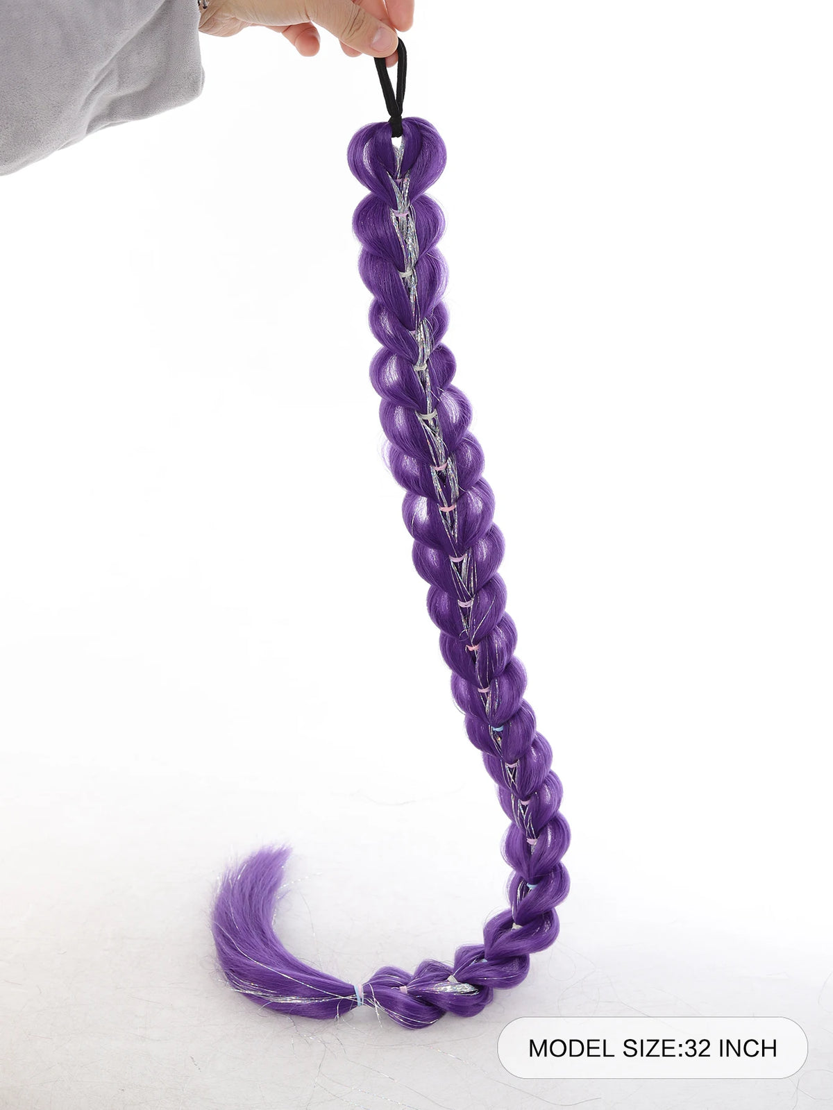 A purple braided hair ponytail with silver tinsel extensions is being held by a hand.