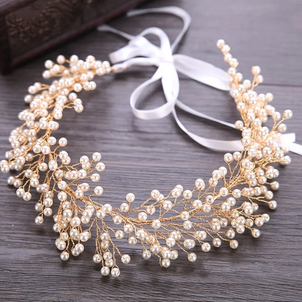 Elegant pearl hair vine headband with delicate gold wire detailing and a white ribbon