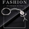 Silver keychain featuring a stickman making a middle finger gesture against a black background.