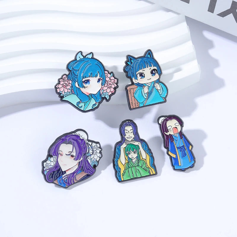 A collection of cute anime character brooches featuring blue-haired female characters with detailed facial expressions and co