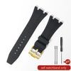 Black sporty silicone watch band with a gold buckle and a black leather strap shown on a white background.
