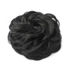 A dark black messy bun hairstyle for curly updos.