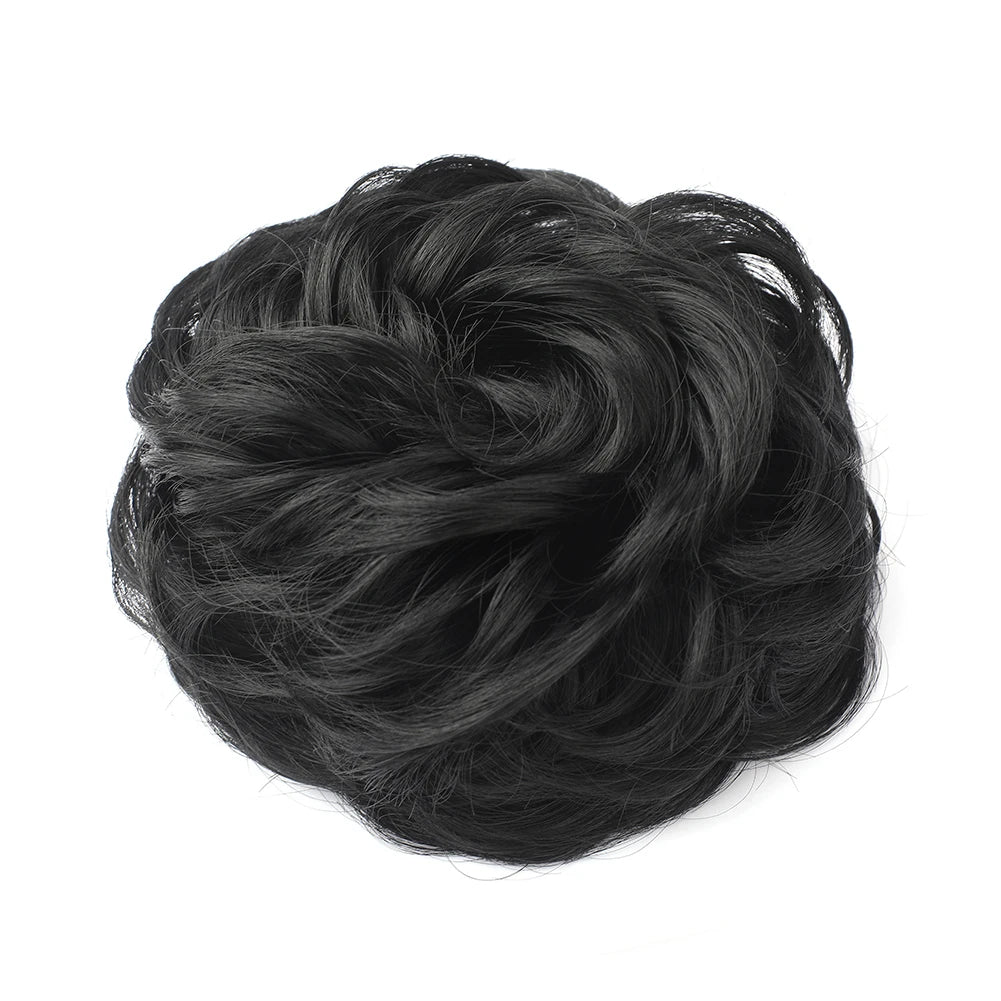 A dark black messy bun hairstyle for curly updos.