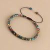 A friendship bracelet made of colorful natural stones and leather cord.